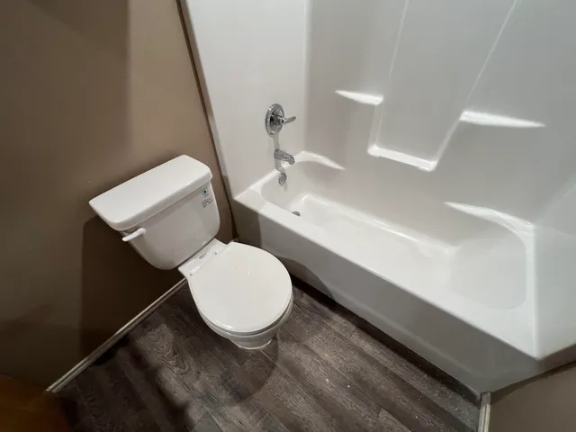 a bathroom with a toilet a sink and a mirror