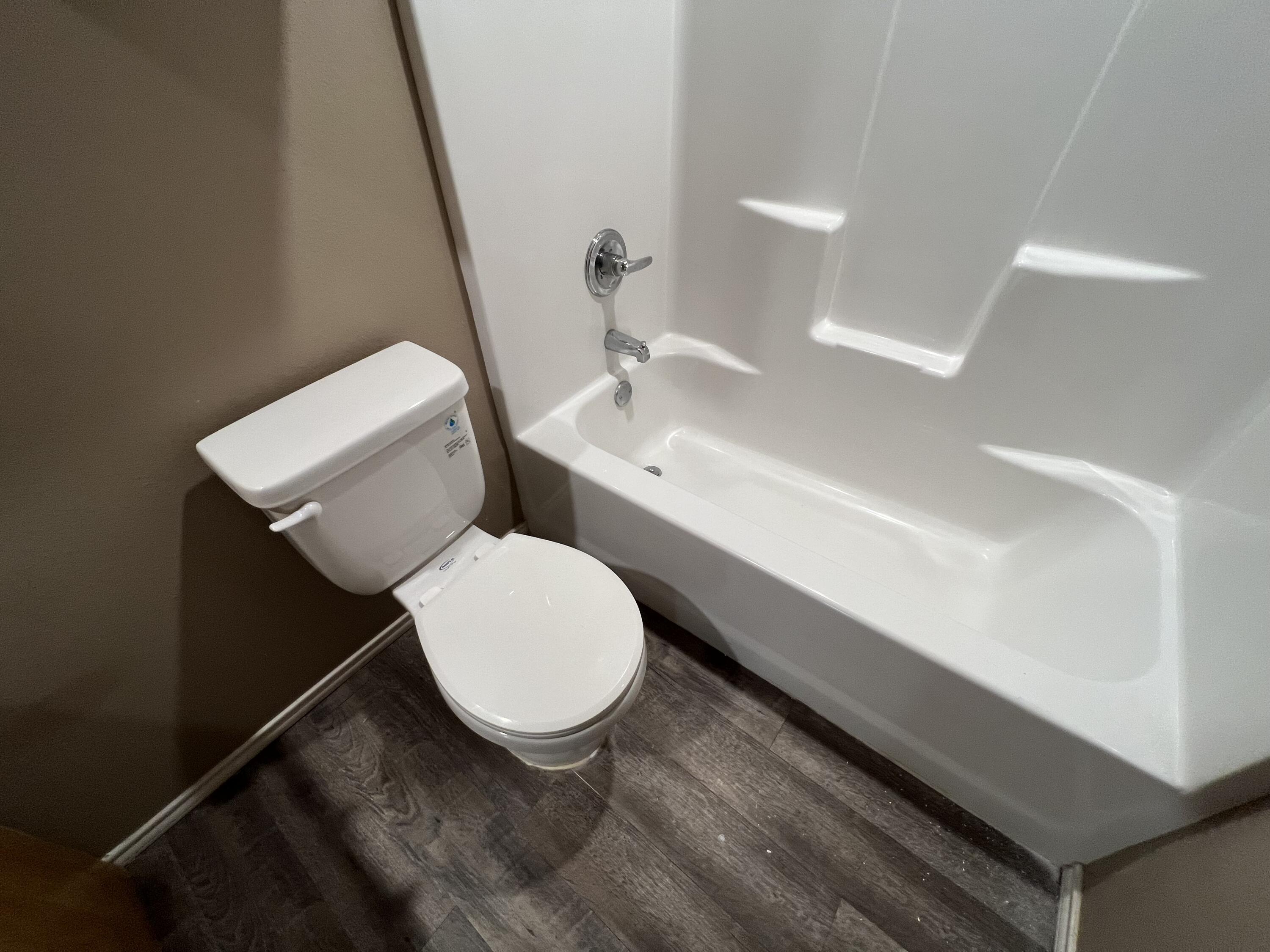 2914 East Cornell Street Lubbock, TX 79403 - Photo 6 of 18 a bathroom with a toilet a sink and a mirror