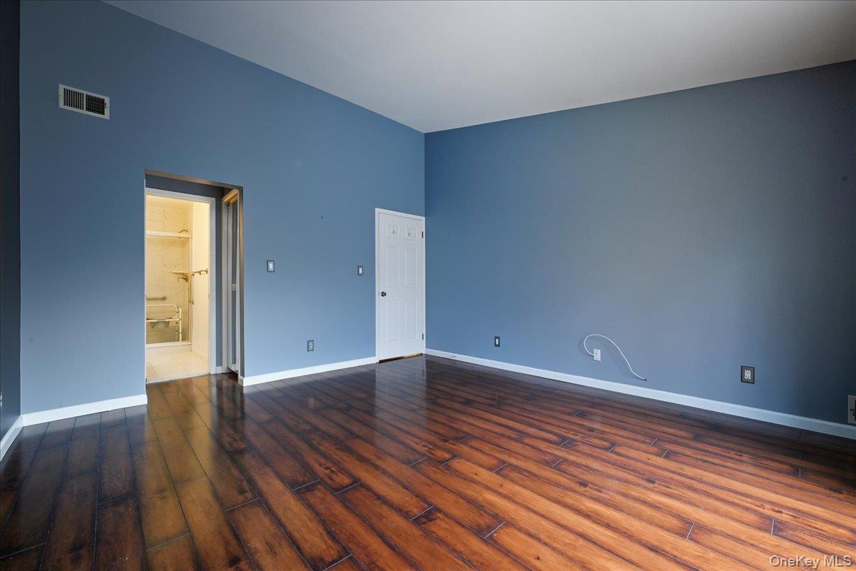 23 Sandy Hill Road Commack, NY 11725 - Photo 15 of 24 a view of an empty room with wooden floor and a window