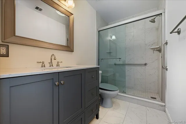 a bathroom with a shower sink vanity and mirror