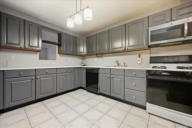 a kitchen with cabinets appliances and a sink
