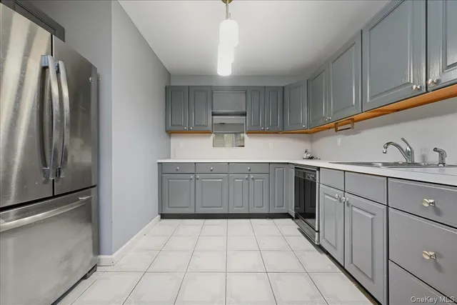a kitchen with a refrigerator sink and cabinets