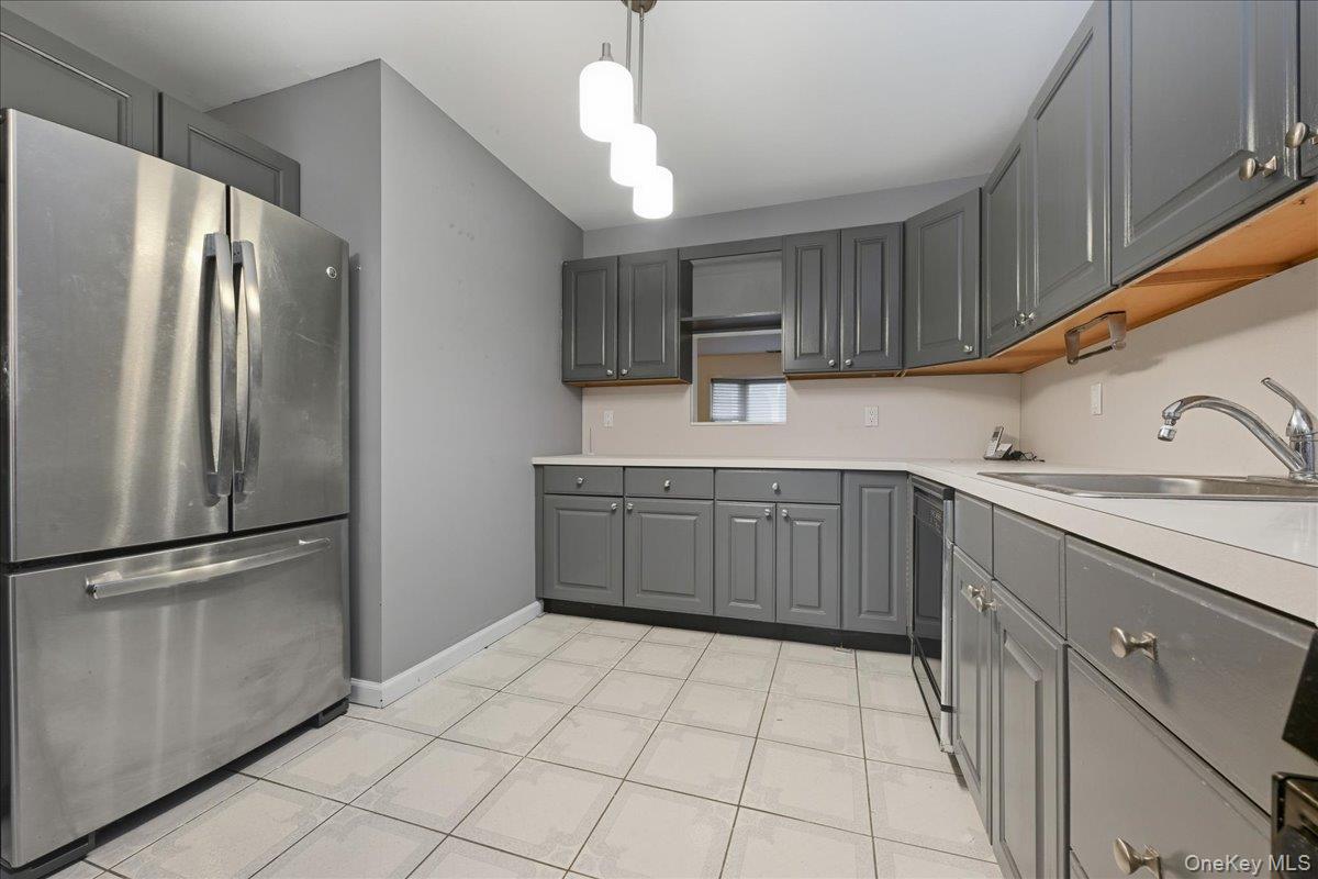 23 Sandy Hill Road Commack, NY 11725 - Photo 9 of 24 a kitchen with stainless steel appliances a refrigerator sink and cabinets