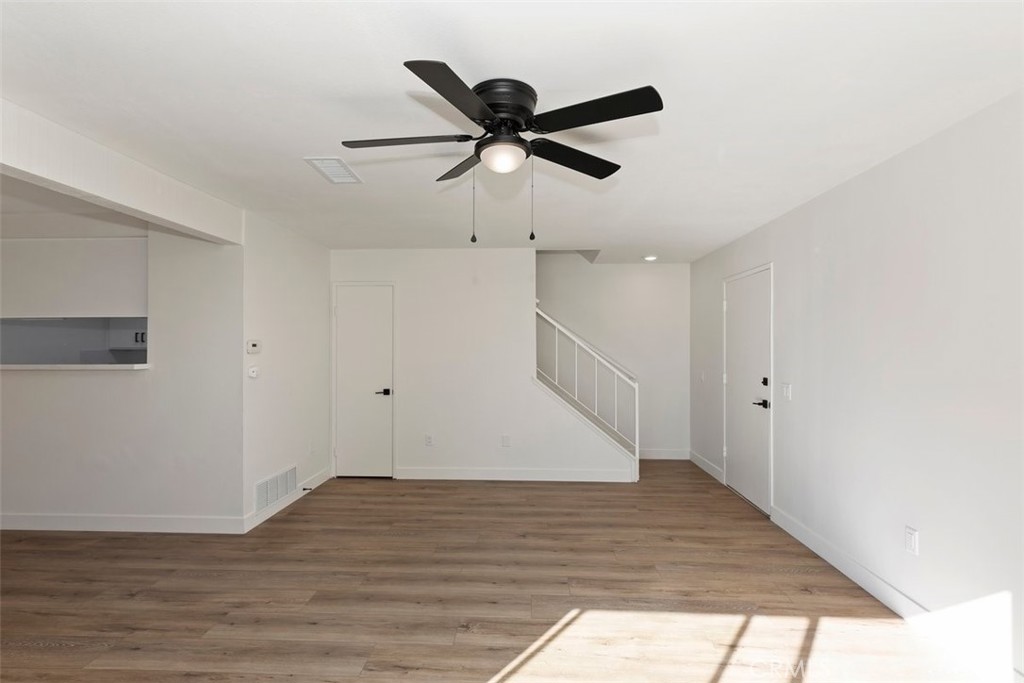 4807 Jackson Street, Unit D Riverside, CA 92503 - Photo 12 of 38 a view of room with wooden floor and ceiling fan