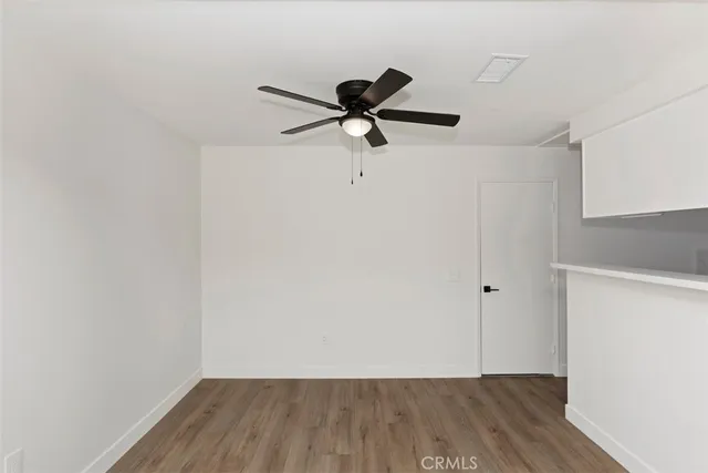 a view of a room with wooden floor