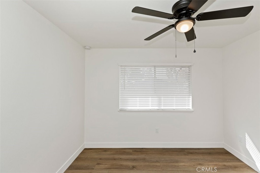 4807 Jackson Street, Unit D Riverside, CA 92503 - Photo 21 of 38 an empty room with wooden floor ceiling fan and window