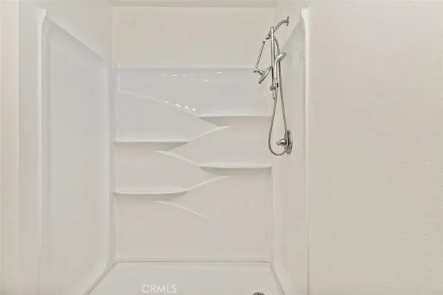 a bathroom with a glass shower door