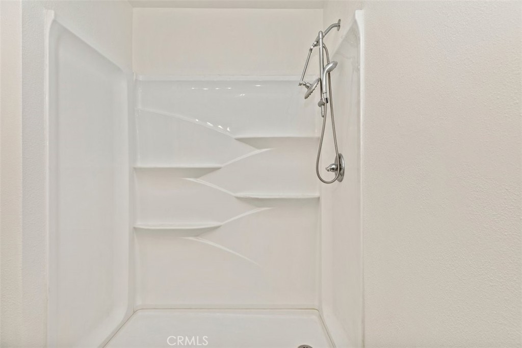 4807 Jackson Street, Unit D Riverside, CA 92503 - Photo 23 of 38 a bathroom with a glass shower door