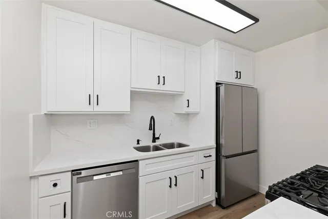 a kitchen with stainless steel appliances a refrigerator and cabinets