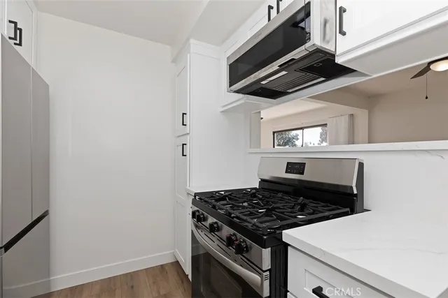 a stove top oven sitting inside of a kitchen