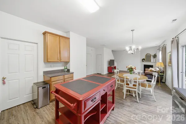 an aerial view of residential houses with outdoor space and trees all around