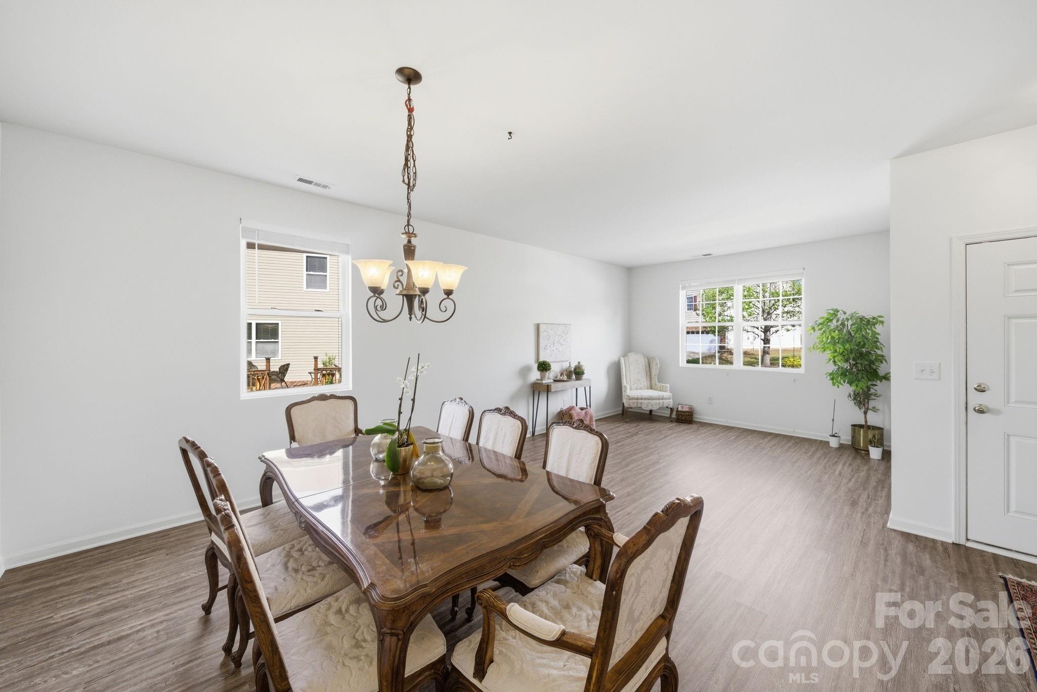 2306 Nettleton Court Matthews, NC 28105 - Photo 14 of 34 a view of a dining room with furniture window and wooden floor