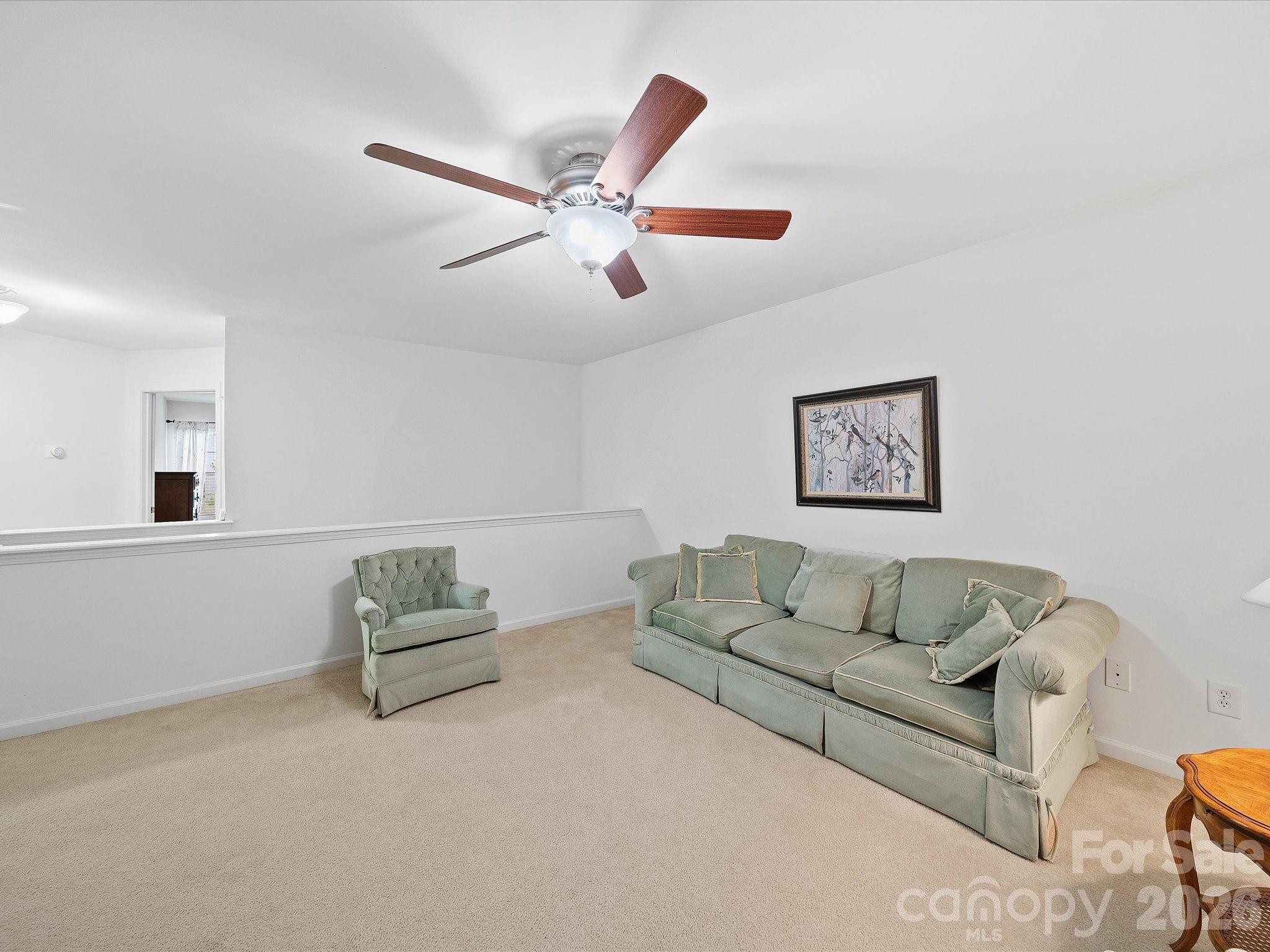 2306 Nettleton Court Matthews, NC 28105 - Photo 17 of 34 a living room with furniture and a wall painting