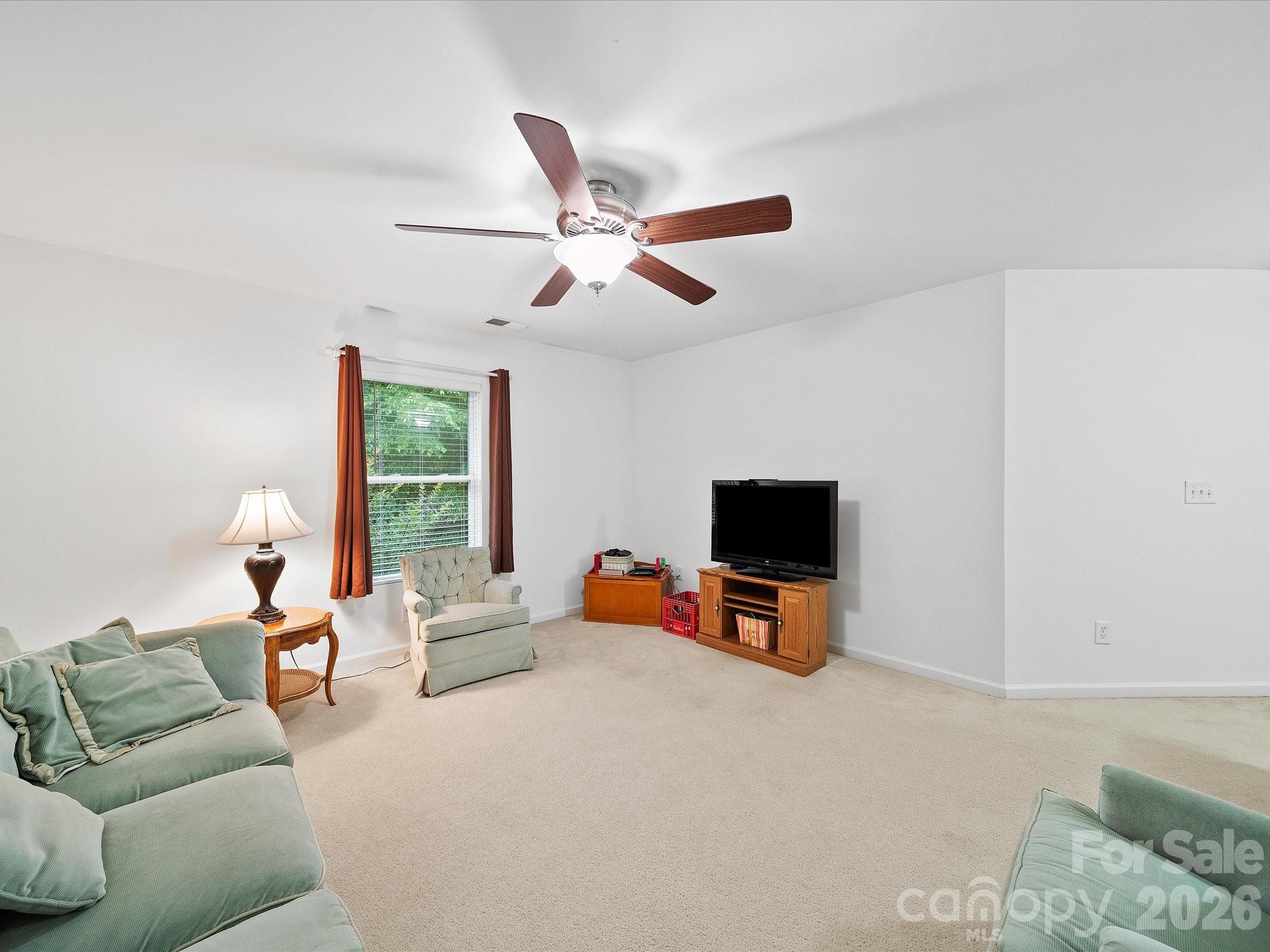 2306 Nettleton Court Matthews, NC 28105 - Photo 18 of 34 a living room with furniture and a flat screen tv