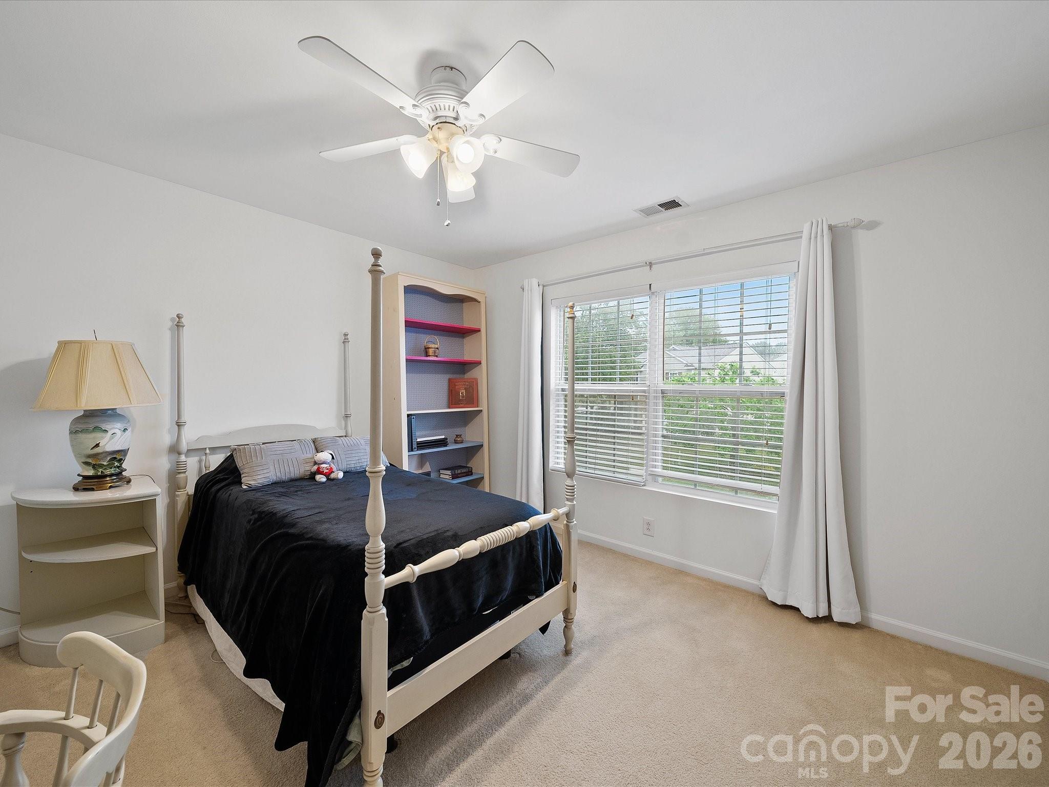 2306 Nettleton Court Matthews, NC 28105 - Photo 25 of 34 a bed room with a bed and a chandelier