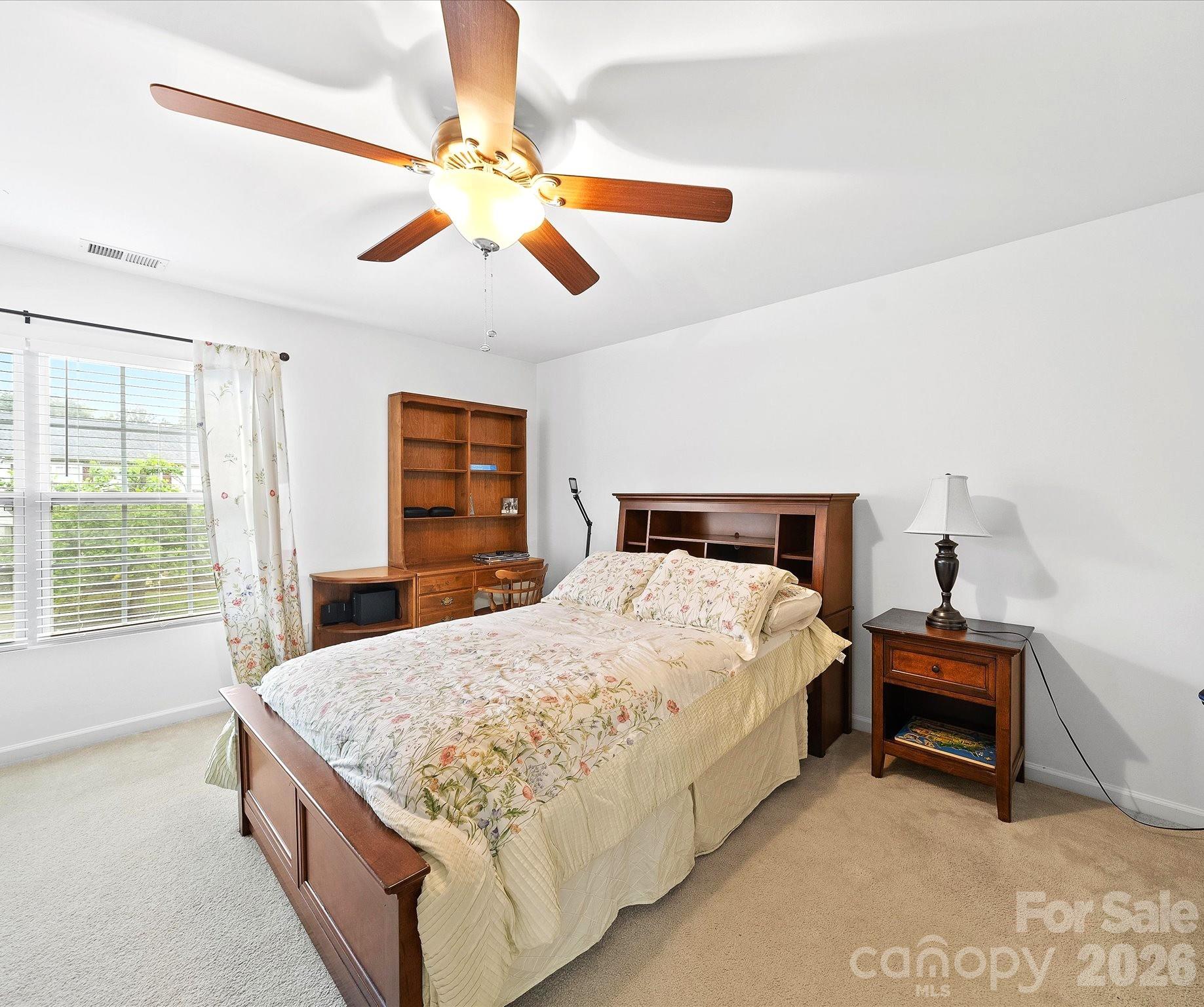 2306 Nettleton Court Matthews, NC 28105 - Photo 28 of 34 a bedroom with a bed and a chandelier