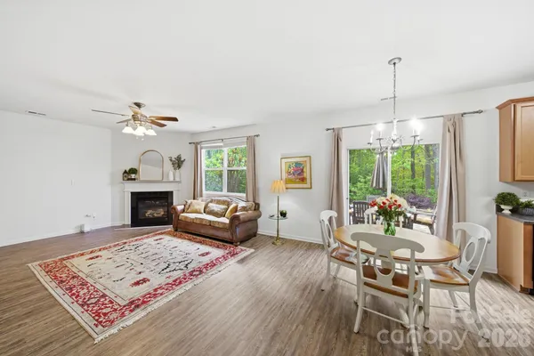 a view of a patio with a table chairs and a barbeque