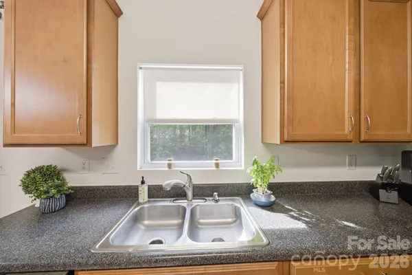 an aerial view of a house with garden space and street view