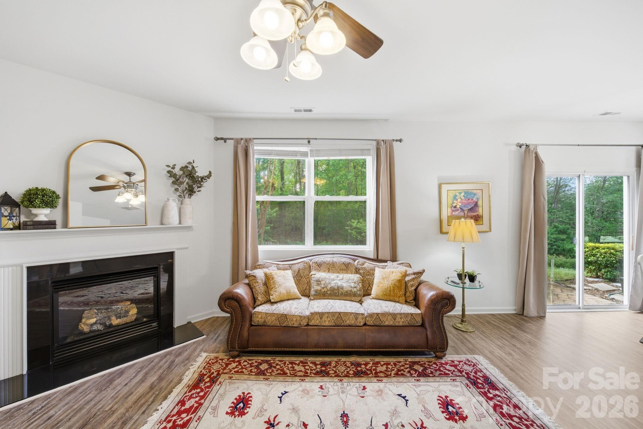 2306 Nettleton Court Matthews, NC 28105 - Photo 10 of 34 a living room with furniture and a fireplace