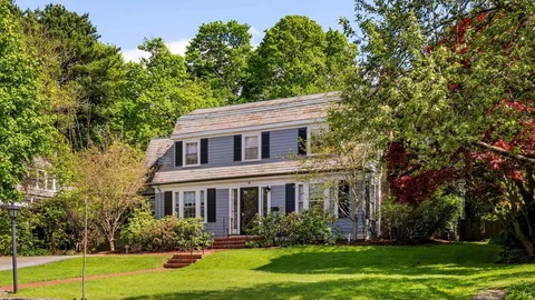 a front view of house with yard and green space