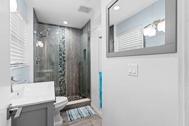 a bedroom with a bed wooden floor and window