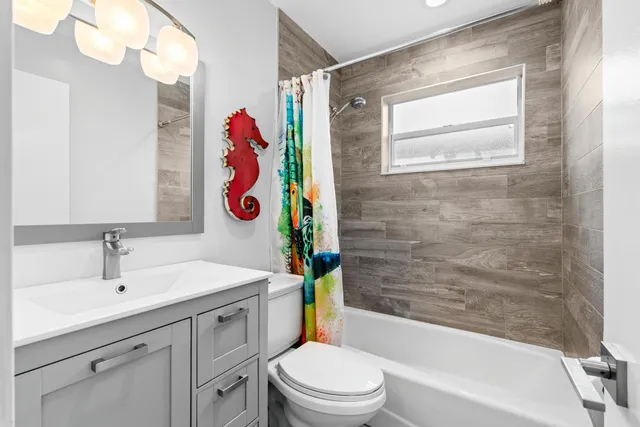 a view of a dining room with furniture and a chandelier