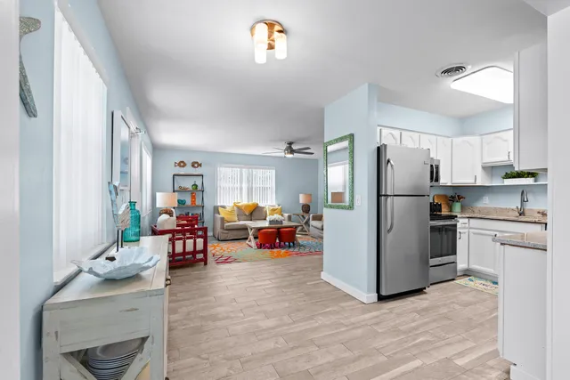 a view of a livingroom with furniture and hardwood floor