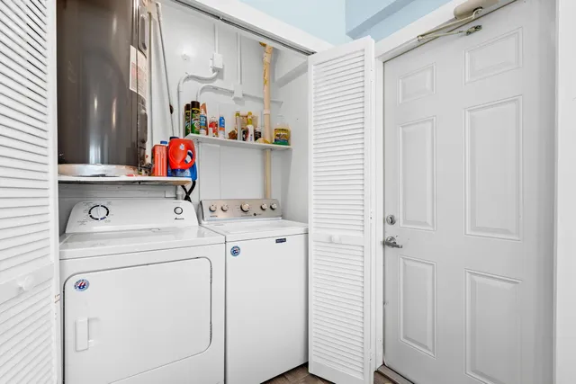 a kitchen with granite countertop a refrigerator and a stove top oven