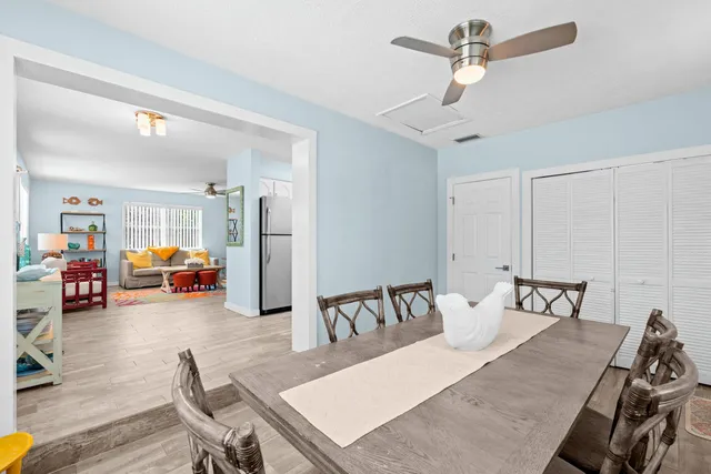 a kitchen with kitchen island granite countertop a sink cabinets stainless steel appliances and a window