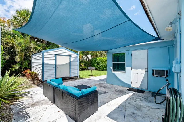 a view of a house with lounge chair and potted plants