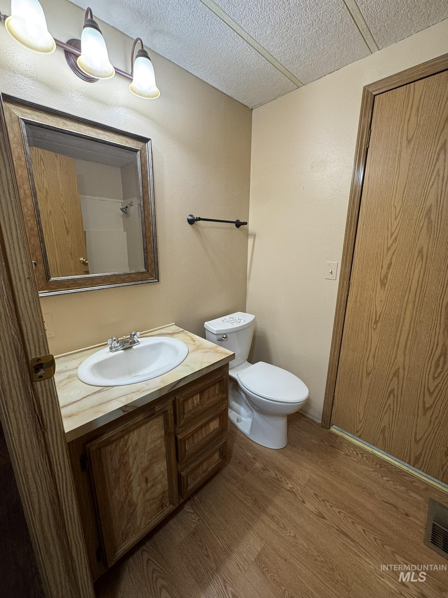 2015 6th Avenue, Unit 308 Clarkston, WA 99403 - Photo 14 of 39 Bathroom with vanity, dark wood-style flooring, and a textured ceiling