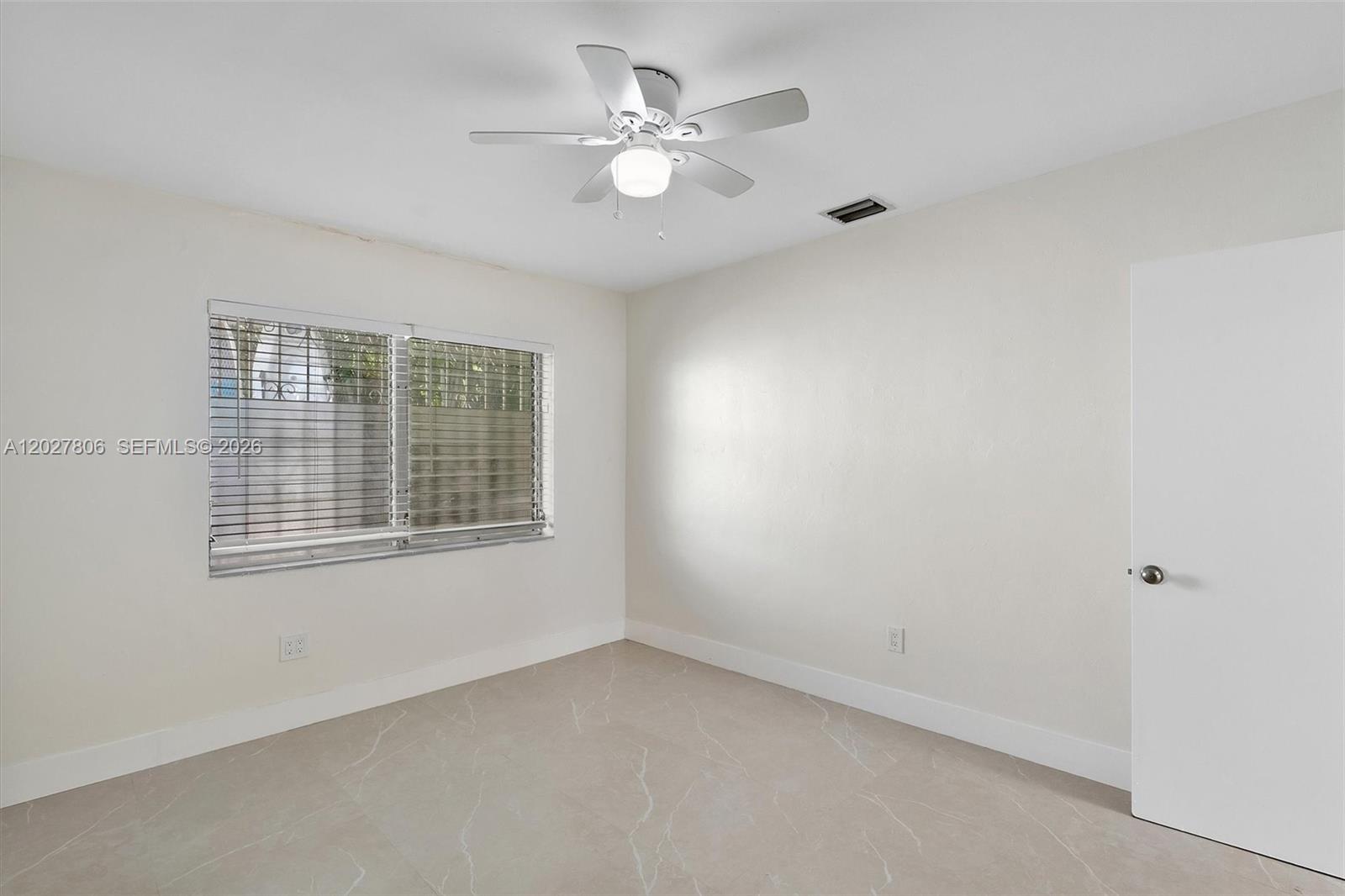 1612 Southwest 23rd Street, Unit 1612 Miami, FL 33145 - Photo 33 of 42 an empty room with windows and ceiling fan