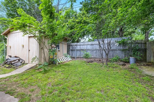 a view of a backyard with a small cabin and a chair