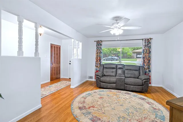 a bedroom with furniture and a large window