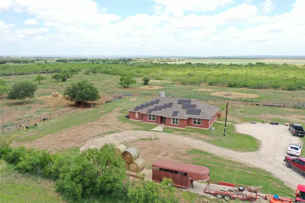 an aerial view of a house with garden space and street view