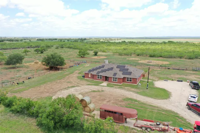 an aerial view of a house with garden space and street view