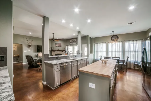 a large kitchen with stainless steel appliances lots of counter top space