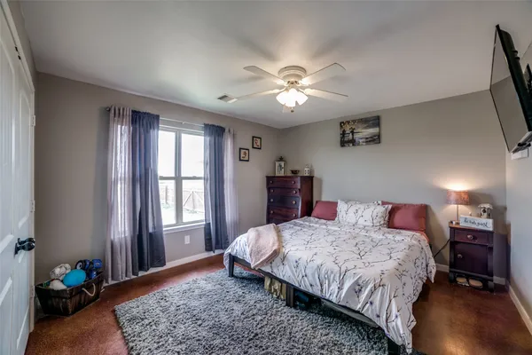 a bedroom with a large bed and a window