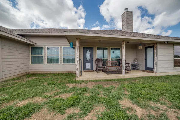 a view of a house with sitting area and a yard