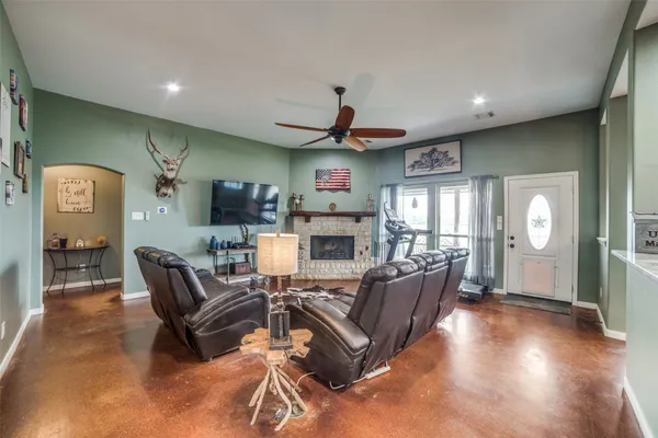 a living room with furniture a fireplace and a flat screen tv