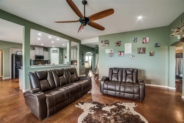 a living room with furniture and kitchen view