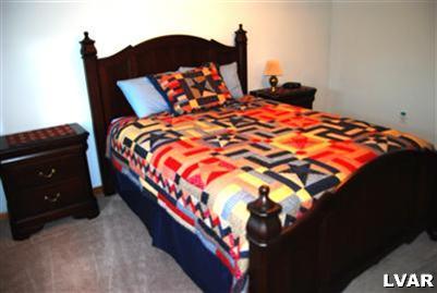 185 West Butternut Road Hellertown, PA 18055 - Photo 8 of 11 a bed sitting in a bedroom next to a lamp