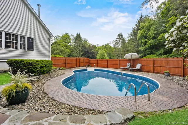 a view of a backyard with swimming pool