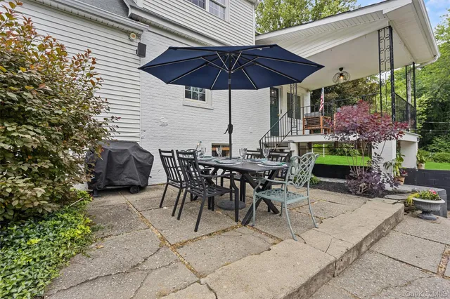 a view of a tables and chairs under an umbrella