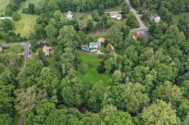 an aerial view of a house with a yard