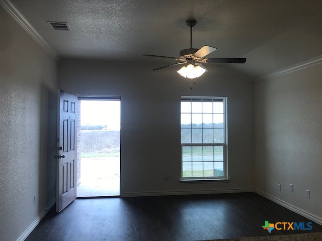 275 Olaf Drive Temple, TX 76504 - Photo 2 of 13 a view of a livingroom with a fan a large window with wooden floor