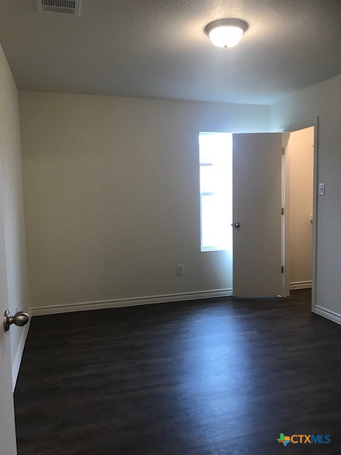 275 Olaf Drive Temple, TX 76504 - Photo 8 of 13 an empty room with wooden floor and windows