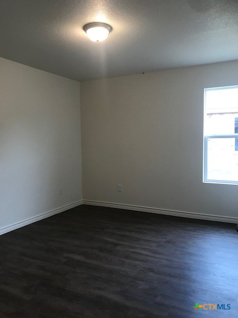 275 Olaf Drive Temple, TX 76504 - Photo 9 of 13 an empty room with wooden floor and windows