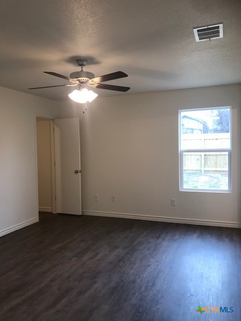 275 Olaf Drive Temple, TX 76504 - Photo 10 of 13 an empty room with wooden floor fan and windows