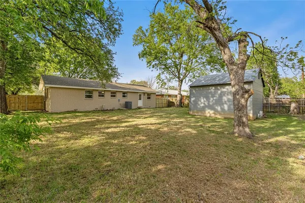 a front view of a house with a yard and a garage